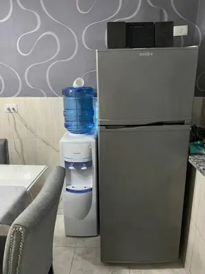 a refrigerator with a water bottle on top of it at Malecon View, Zona Colonial in Santo Domingo