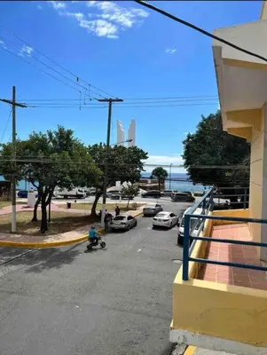 a street with cars parked in a parking lot at Malecon View, Zona Colonial in Santo Domingo