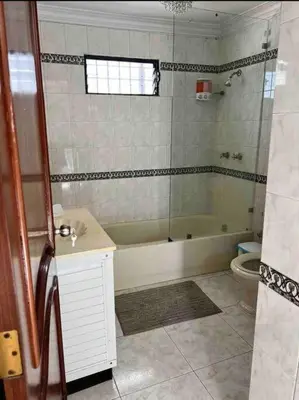 a bathroom with a tub and a sink and a toilet at Malecon View, Zona Colonial in Santo Domingo