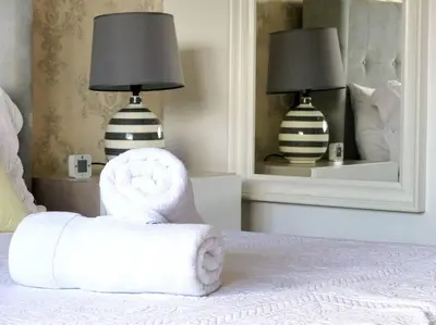 a bedroom with a bed with a chair and a mirror at Dreams Room Soha II in Santiago de los Caballeros