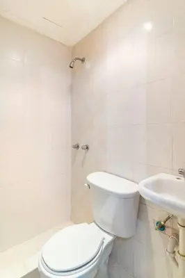 a white bathroom with a toilet and a sink at Gateway For You And Your Loves Ones I Sleeps 6 in Santo Domingo