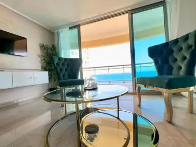 a living room with a glass table and two chairs at Gateway For You And Your Loves Ones I Sleeps 6 in Santo Domingo