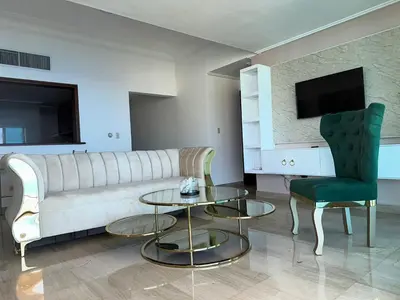 a living room with a couch and a table and a chair at Gateway For You And Your Loves Ones I Sleeps 6 in Santo Domingo