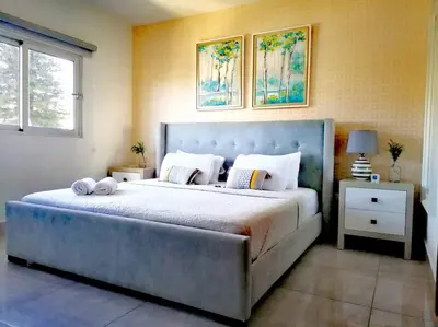 a bedroom with a large bed with two pillows on it at Suites Room Soha II in Santiago de los Caballeros