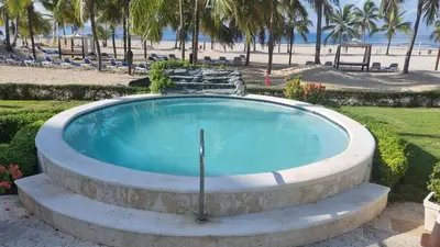 a hot tub with a beach in the background at Your Little Paradise - Juan Dolio in Juan Dolio