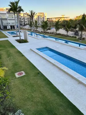 an overhead view of a swimming pool at a resort at LUXURY CONDO Cana Bay 1 CLUB BEACH in Punta Cana