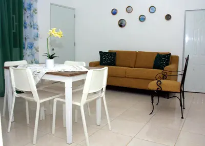 a living room with a table and chairs and a couch at Complejo Giraflor in Pantoja