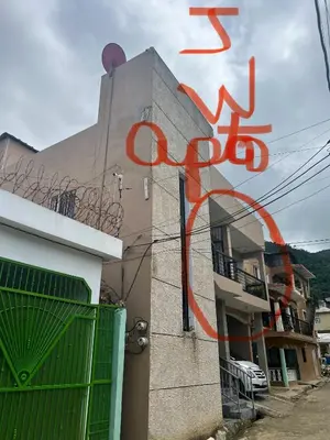 a building with an orange painting on the side of it at J&W apartment in San Felipe de Puerto Plata