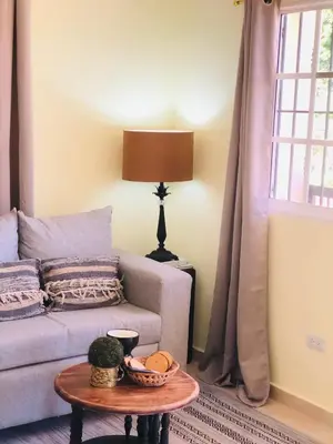 a living room with a couch and a table at J&W apartment in San Felipe de Puerto Plata