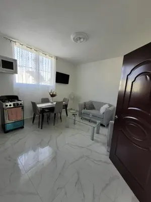 a living room with a table and a couch at Departamento Luna en Santo Domingo in Santo Domingo