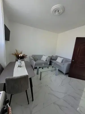 a living room with a couch and a table at Departamento Luna en Santo Domingo in Santo Domingo
