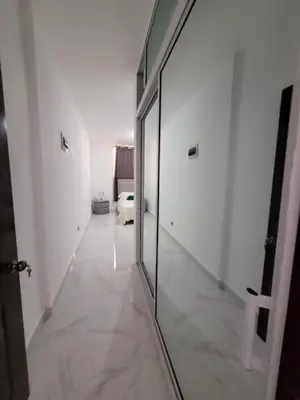 a hallway with a mirror in a white room at Departamento Luna en Santo Domingo in Santo Domingo