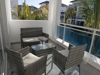 a balcony with chairs and a table on a balcony at Caribbean Star - Estrella Dominicus Bayahibe in Bayahibe