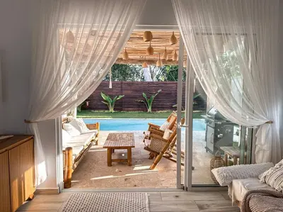a living room with a view of a patio at Villa Saule in Bombita