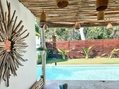 a view of a swimming pool with a wooden wall at Villa Saule in Bombita