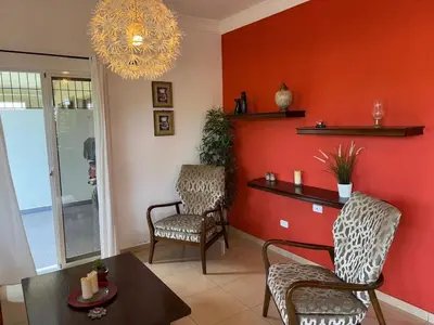 a living room with two chairs and a table at Casa Canephora in Las Galeras