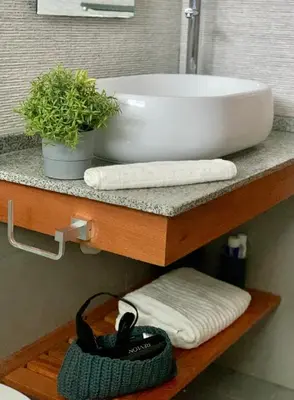a bathroom sink on a shelf with towels and a plant at Apartment in Estrella, Dominicus-Bayahibe in La Laguna