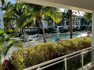 a view of a resort with palm trees and a swimming pool at Apartment in Estrella, Dominicus-Bayahibe in La Laguna