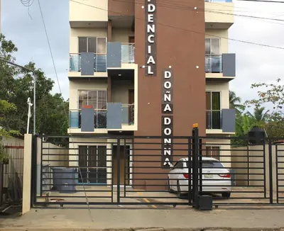 a building with a sign for a hotel at Casa Bonita Pimentel in Pimentel