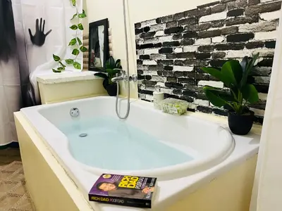a bathroom with a bath tub with a magazine on it at Casa Bonita Pimentel in Pimentel