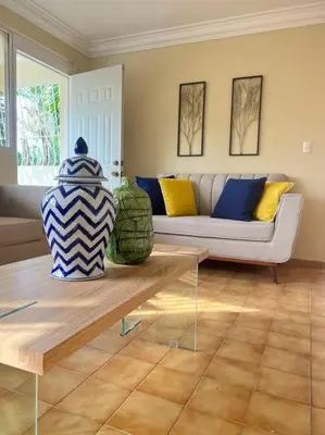 a living room with a couch and a table at LA CASA DE MAMA LUZ in San Felipe de Puerto Plata