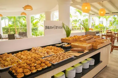 a bakery with a buffet of pastries and bread at Hotel HM Alma de Bayahibe - Adults Only - All Inclusive in Bayahibe