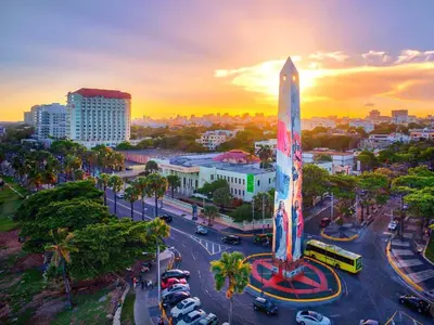 a city with a tall tower in the middle of a street at Suites By SalcedO in Santo Domingo
