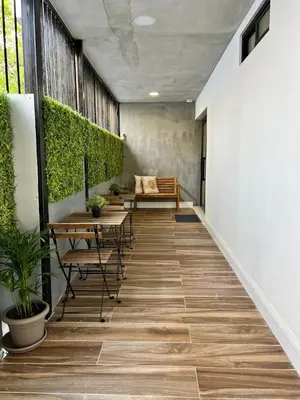 a corridor with benches and tables in a building at Suites By SalcedO in Santo Domingo