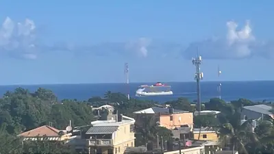 a large boat in the water near a city at Royal Terrace V (Duque) in San Felipe de Puerto Plata