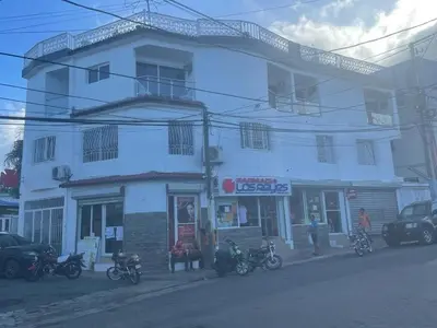 a white building with motorcycles parked in front of it at Royal Terrace IV (King) in San Felipe de Puerto Plata