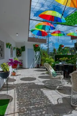 a patio with colorful umbrellas hanging from a ceiling at Royal Terrace IV (King) in San Felipe de Puerto Plata