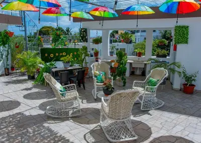 a patio with chairs and colorful umbrellas at Royal Terrace III (Prince) in San Felipe de Puerto Plata