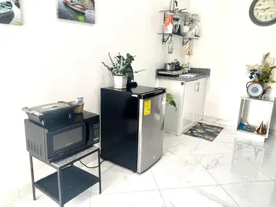 a kitchen with a refrigerator and a microwave at Royal Terrace III (Prince) in San Felipe de Puerto Plata
