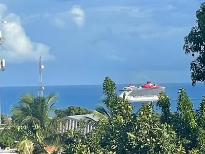 a cruise ship in the ocean with trees at Royal Terrace III (Prince) in San Felipe de Puerto Plata