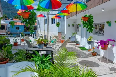 a patio with colorful umbrellas hanging from the ceiling at Royal Terrace Apto. II (Princess) in San Felipe de Puerto Plata