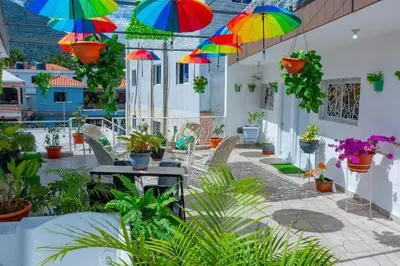 a patio with colorful umbrellas hanging from the ceiling at Royal Terrace I (Queen ) in San Felipe de Puerto Plata