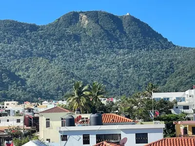 a mountain in the background of a city with houses at Royal Terrace I (Queen ) in San Felipe de Puerto Plata